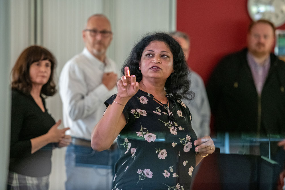 Woman pointing towards presentation on a wall